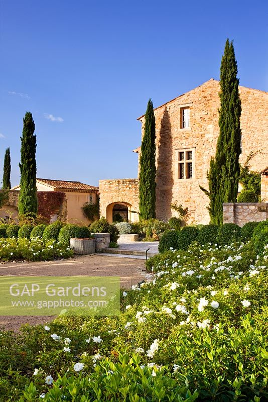 View of the property with the white garden in the foreground. Provence, France, Domaine de la Verriere 
