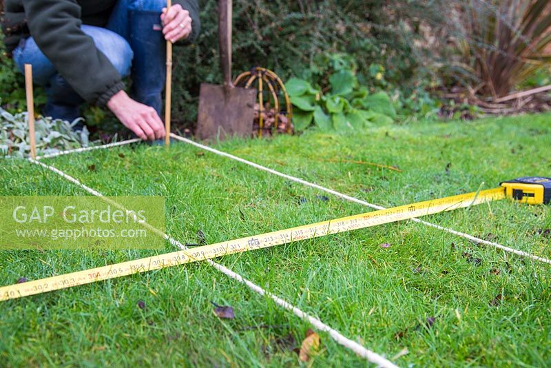 Measuring distances and aligning rope for digging trench