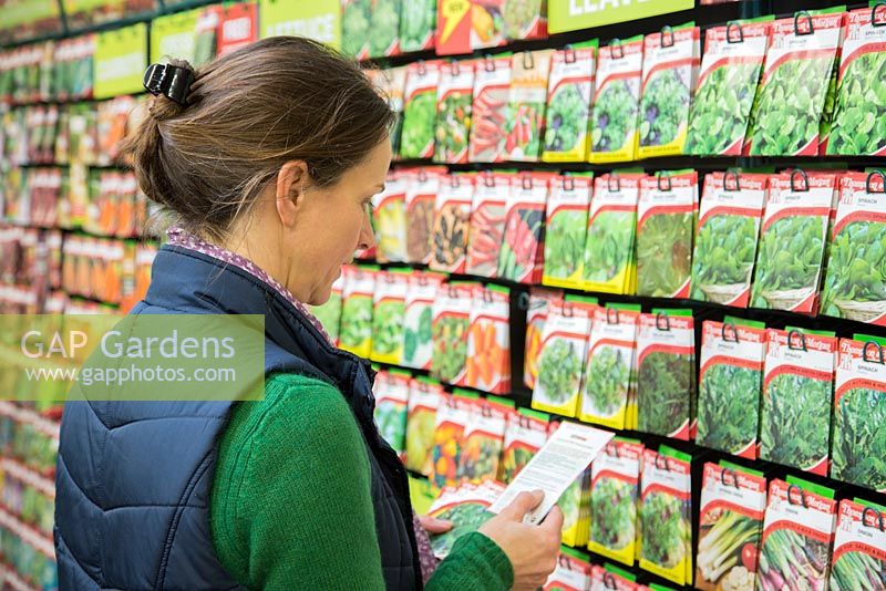 Woman shopping for seeds in a garden centre