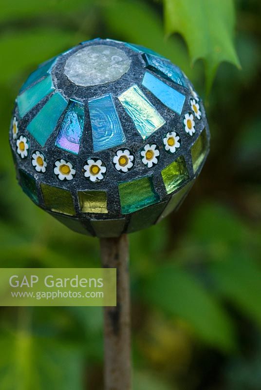 Mosaic ball on stick by Anne Cardwell in town garden