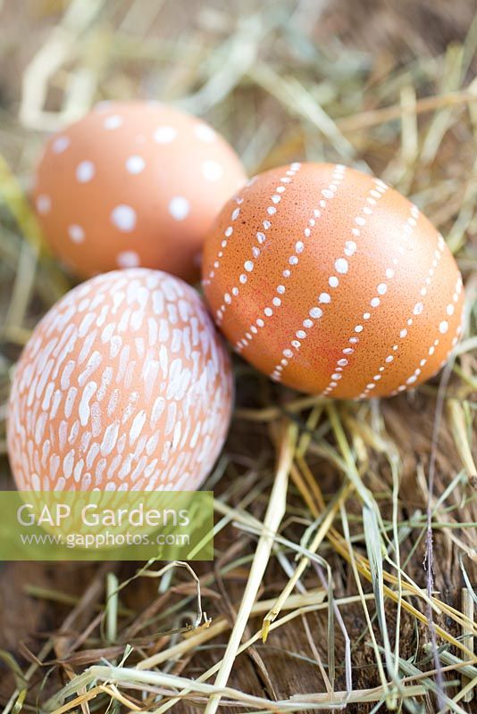 Easter display of decorated eggs amongst straw