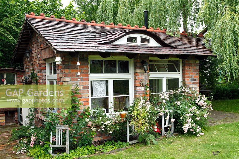 Summer house with Rosa 'Swany', Rosa 'The Fairy', Rosa 'Muttertag', Rosa 'Lovely Meidiland' in June