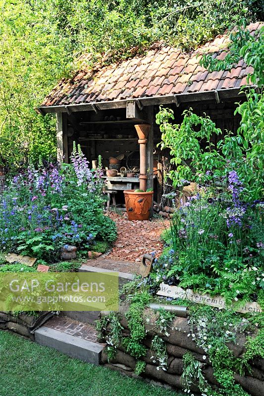 Stone steps, gravel and crock path leading to potting shed