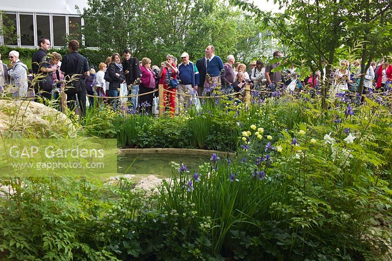 Crowds visiting the RHS Chelsea Flower Show. The Homebase Garden - 'Time to Reflect' with Alzheimer's Society. Gold medal winner