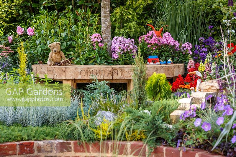 Colourful planting and children's toys from different eras - The NSPCC Legacy Garden, RHS Hampton Court Flower Show 2014