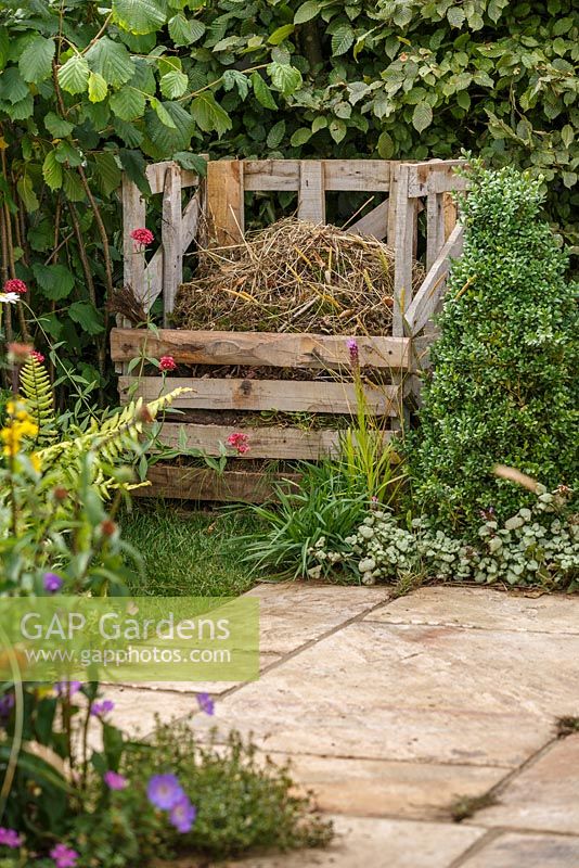 Wooden compost bin and stone paving, The Visible Garden, RHS Hampton Court Flower Show 2014