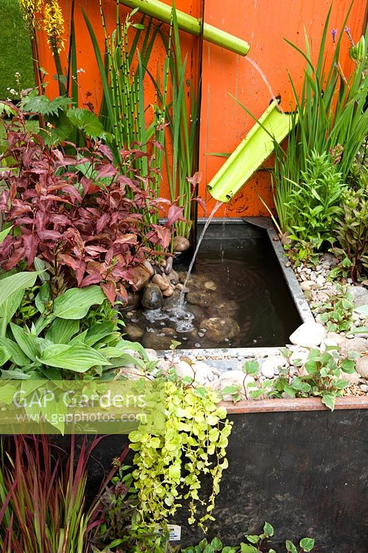 Metal. A Space to Connect and Grow. Detail of  creative use of recycled materials including Farm machinery parts formed into water cascade draining water into planted steel tub. Designer: Jeni Cairns and Sophie Antonelli Sponsor: Metal Gold award best summer garden