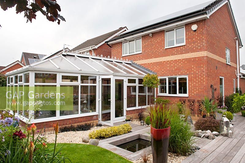 Rear of house showing the conservatory overlooking the garden - Acreswood