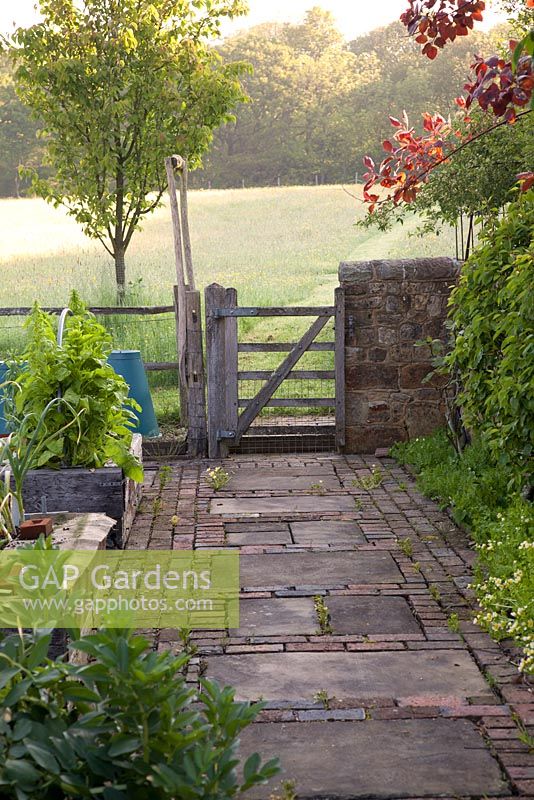 Garden gate leading out onto open countryside in spring