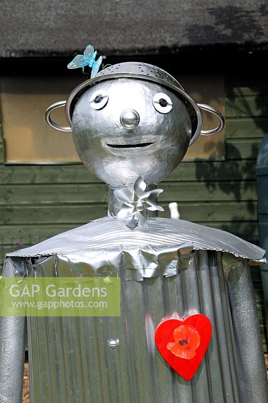 The Tin Man Scarecrow from The Wizard of Oz with colanders for hat and a red heart, Paddock Allotments 