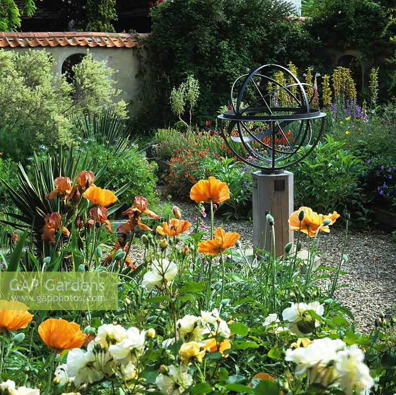 Walled, mediterranean garden with armillary sphere amidst beds of Papaver Turkish Delight, Rosa White Pet, foxtail lilies, Iris Bronze Bird and asphodeline.