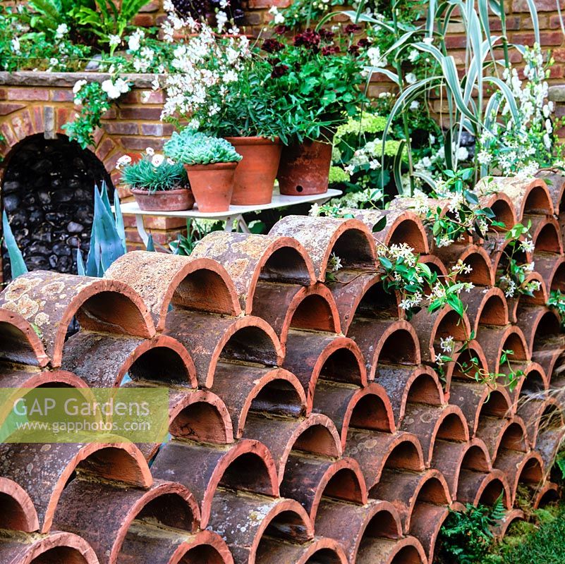 A low garden wall created from reclaimed terracotta ridge tiles.