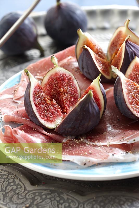 Ficus carica - fresh figs on plate with ham