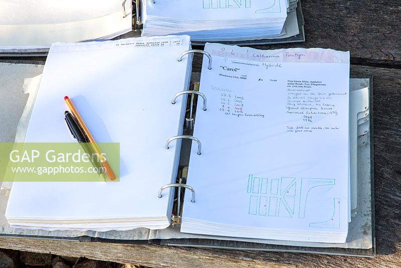 Folders with meticulous notes used as garden notebooks 