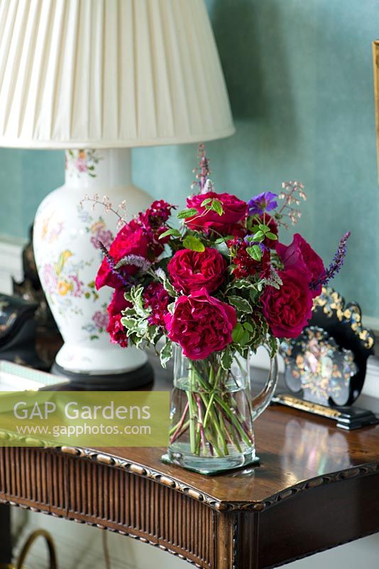 Red roses in a cut flower arrangement on a side table