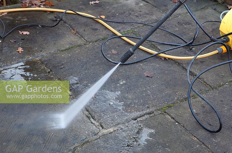 Using a Karcher high pressure jet spray to clean a patio surface