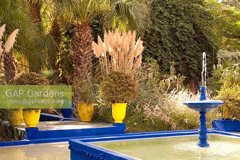 Blue fountain and pool in Jardin Majorelle in Marrakech, Morocco