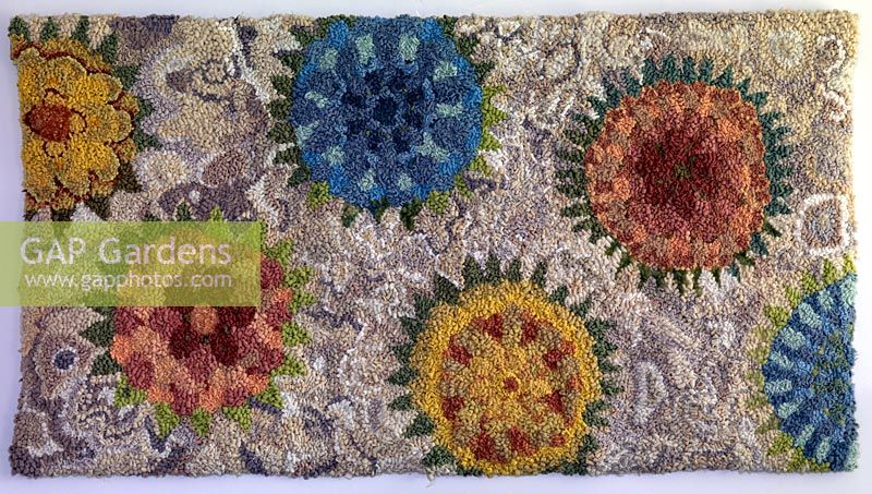 Handmade rag rug, inspired by seaside motifs, and crafted from textiles collected from second hand charity shops.