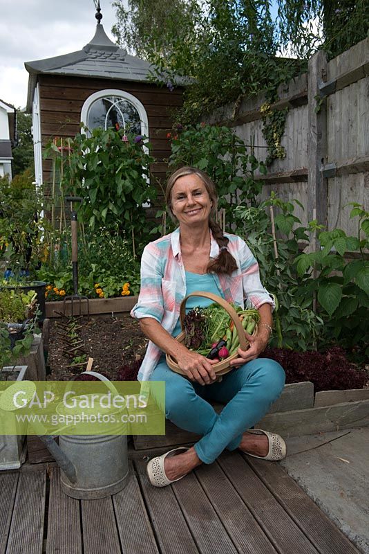 Nicola Stocken, photographer and writer, with the harvest from her vegetable bed in it's first year.