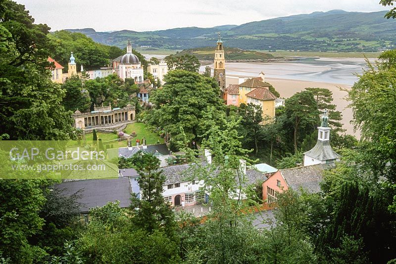 Portmeirion. View of village, designed by Sir Clough William-Ellis, on hillside overlooking bay, on peninsula in Snowdonia, North Wales.