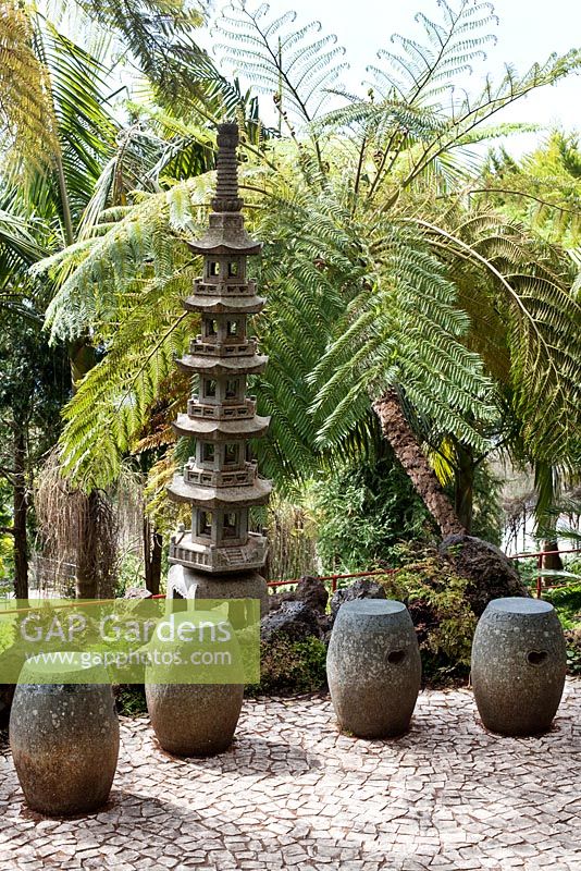 Seats in Oriental garden at Monte Palace Tropical Garden, Madeira, with Japanese pagoda and tree ferns