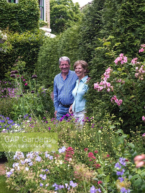 Jenny and Richard Raworth between herbaceous beds in their lovely summer garden.