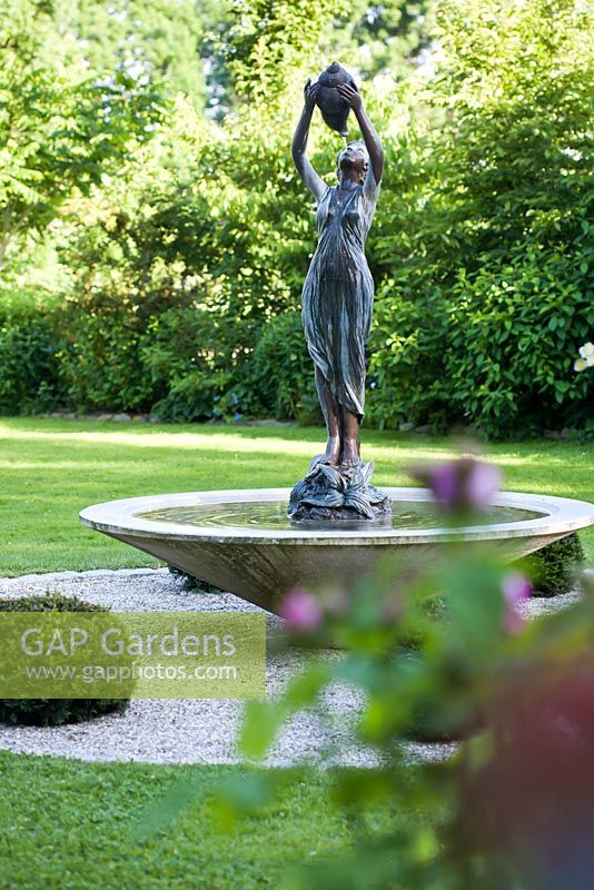 Water feature with woman statue.