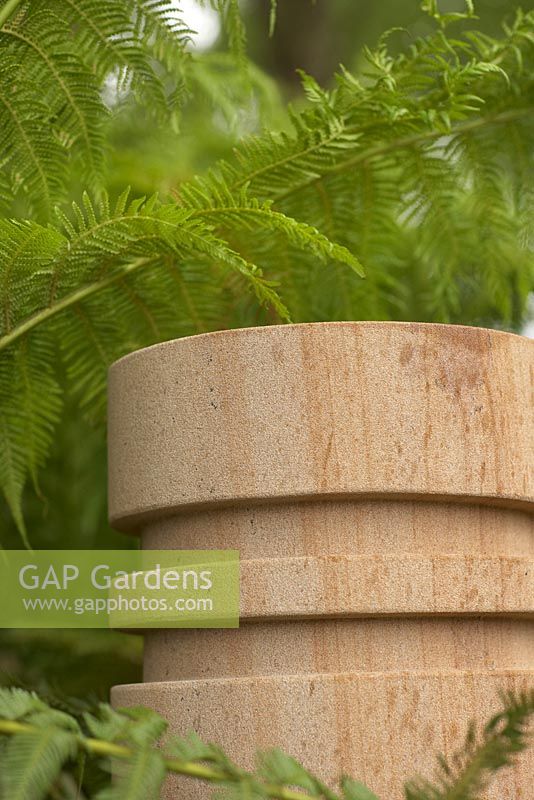 The Time In Between by Husqvarna and Gardena.  Sandstone pillar with ferns. 