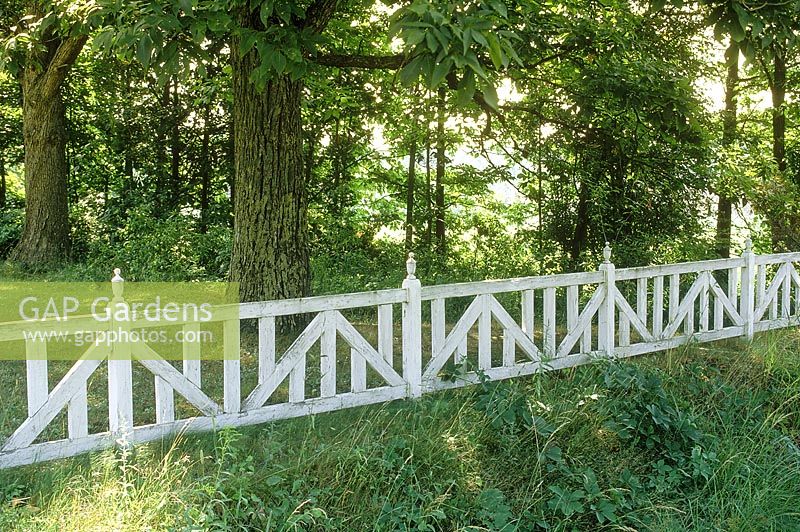 Ornamental white wooden fence. Michigan, USA