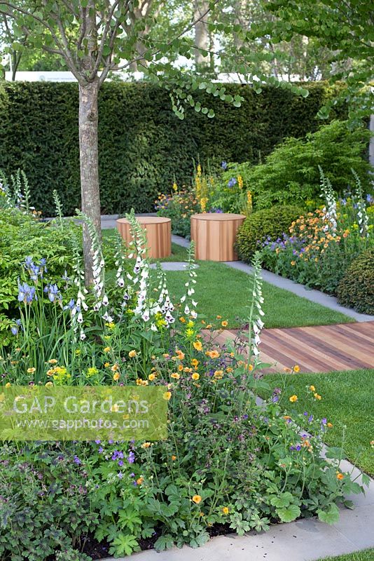 Garden overview displaying wooden decking and seating area. The Homebase Urban Retreat Garden. RHS Chelsea Flower Show 2015