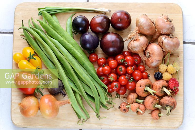 Picked vegetables and fruit - Spring onions,  Runner beans, Tomato 'Indigo Rose', 'Ildi'  'Sweet Baby', Shallots 'Red Sun', Beetroot,  Onion 'Stuttgarter', Carrot 'Parmex', Raspberries and Blackberry