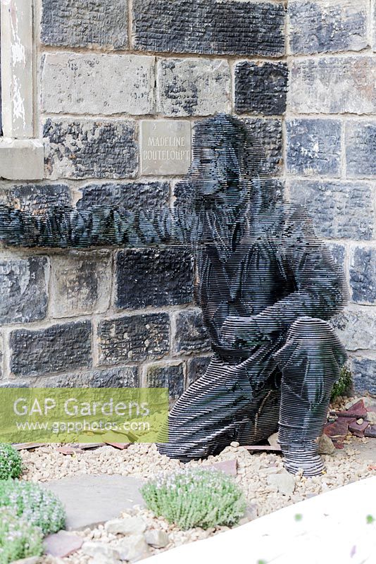 Sculpture of pilot hiding in ruins of a war-damaged church. The Evaders Garden by Chorley Council. RHS Chelsea Flower Show, May 2015