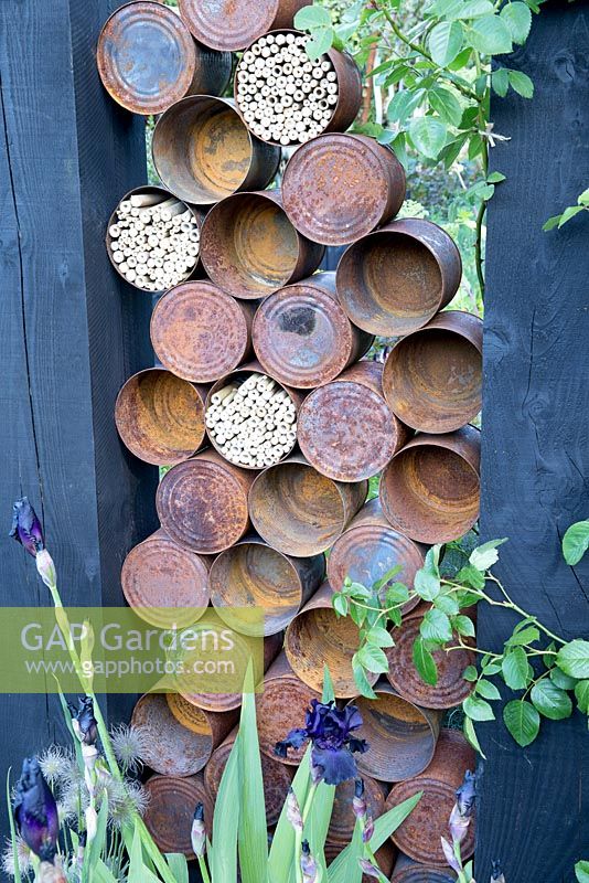 The Great Chelsea  Garden Challenge garden - old rusty tin cans and insect hotel, bee wildlife friendly habitat 