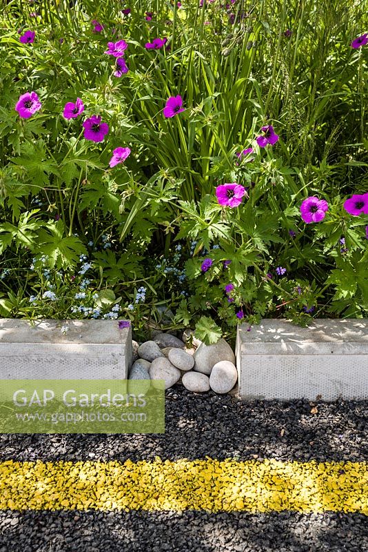 Kerbside planting including Geranium psilostemon with pebble detail - Community Street - RHS Hampton Court Flower Show 2015