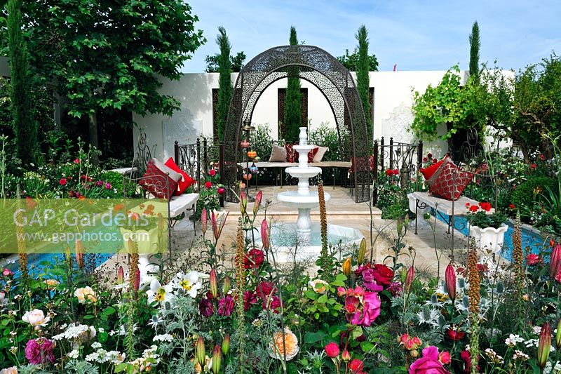 Turkish garden of paradis with fountain, pools, cypresses and flowerbeds - RHS Hampton Court Palace Flower Show 2015 