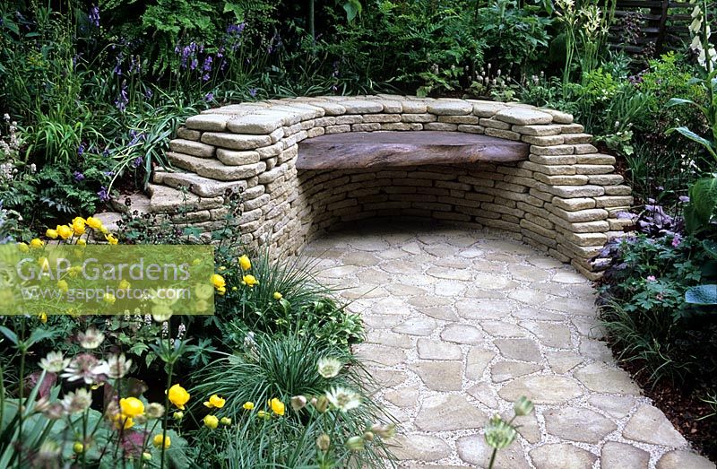 Wooden bench set in stone wall