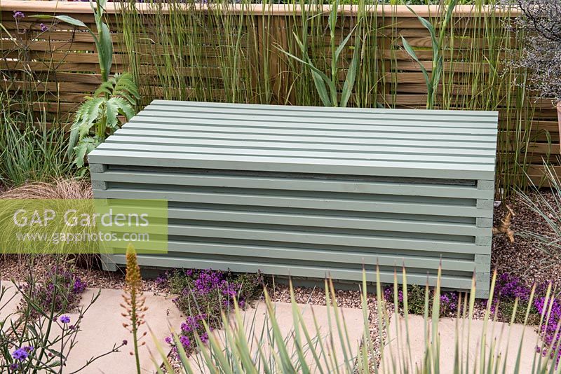 Jacksons Secret Garden Party. A wooden bench conceals a water storage tank. Designer: Jon Sims.