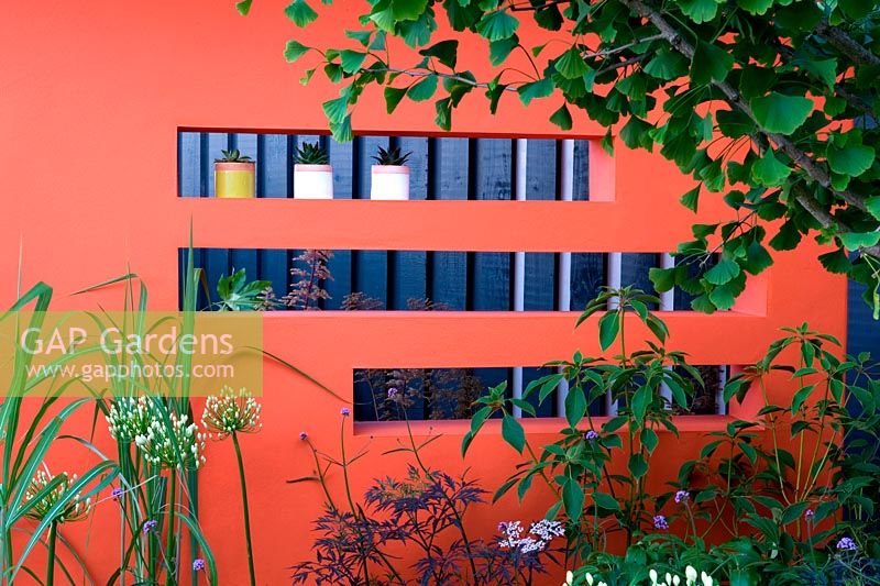 Creations Mid Century Modern - Best Low Cost High Impact Garden. RHS Hampton Court 2013. Orange moongate wall divider. Design: Adele Ford and Susan Willmott Sponsor: Outdoor Creations
