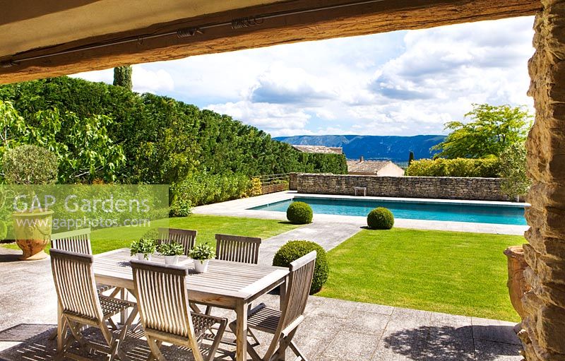 View from pool house to lawn and swimming pool. Luberon, France. 
