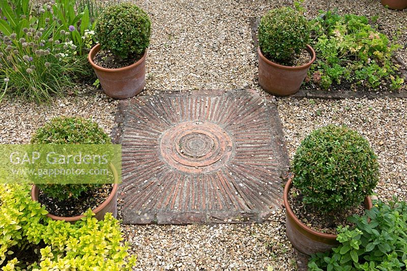 Salterns Cottage, a private garden on the Isle of Wight. Paving with circular pattern.