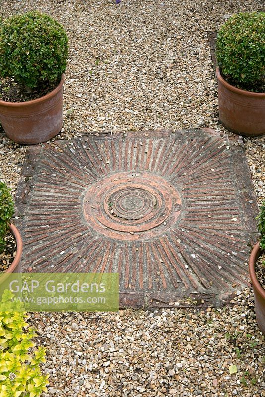 Paving with circular pattern. Salterns Cottage, a private garden on the Isle of Wight. 