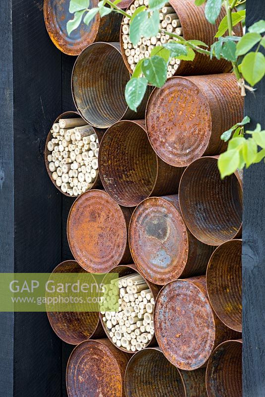 The Great Chelsea Garden Challenge Garden. Rusted alluminium cans used for insect hotels. Designer - Sean Murray. Sponsor - Royal Horticultural Society