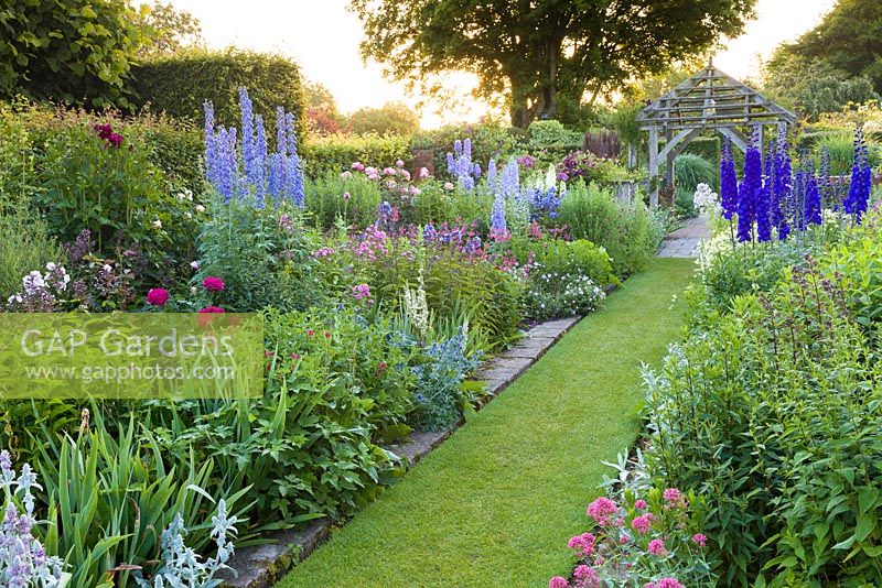 The Sundial Garden at Wollerton Old Hall Garden, Wollerton, Shropshire - featuring David Austin roses, Stachys, Delphiniums, Dahlias, Phlox paniculata, Salvia microphylla and Centranthus ruber, among a wide range of other herbaceous plants. 