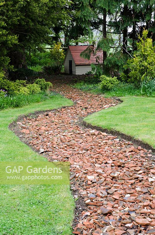 Recycled tile path leading towards the Clarice Cliff Garden