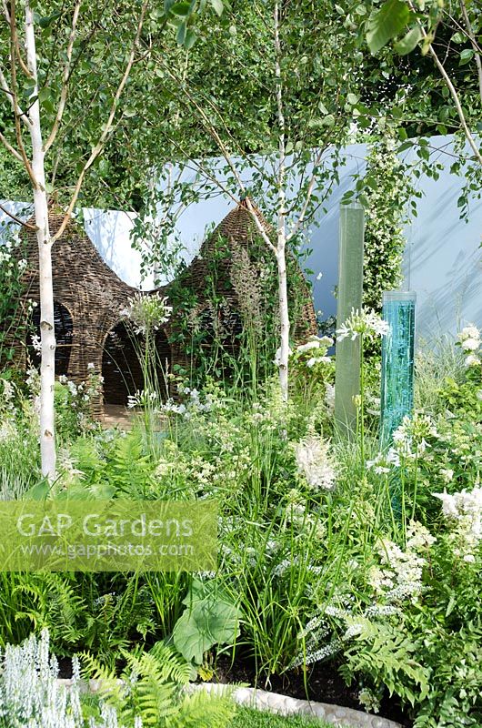 Willow playhouse, sensory tubes, Betula underplanted with white planting of Agapanthus, Hydrangea, and Ferns - Corner of the World, RHS Hampton Court Palace Flower Show 2012