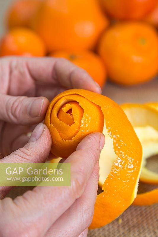 Wrap the orange peel around itself to create a flower shaped head