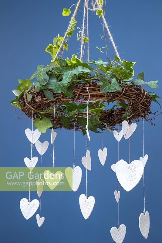 Clay hearts featuring impressions from conifer foliage, hanging from an Ivy covered wreath