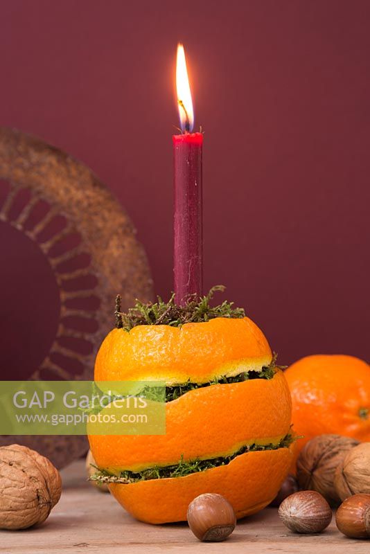 A candle holder made from Orange peel and moss