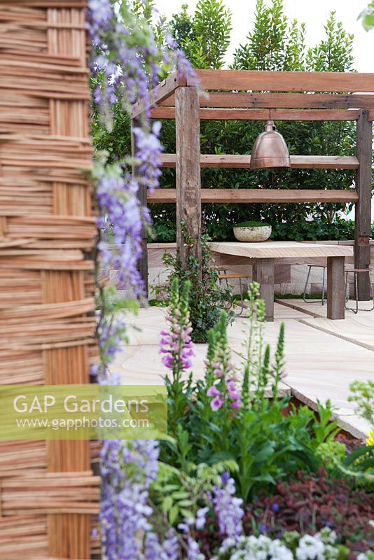 Recycled timber pergola and sandstone outdoor dining table