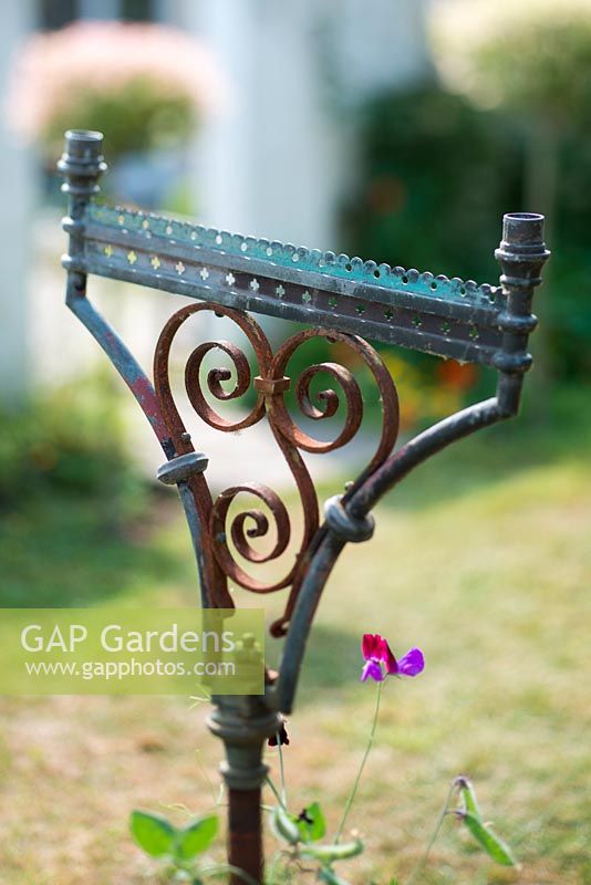 Vintage brass and wrought iron candle holder in wild garden